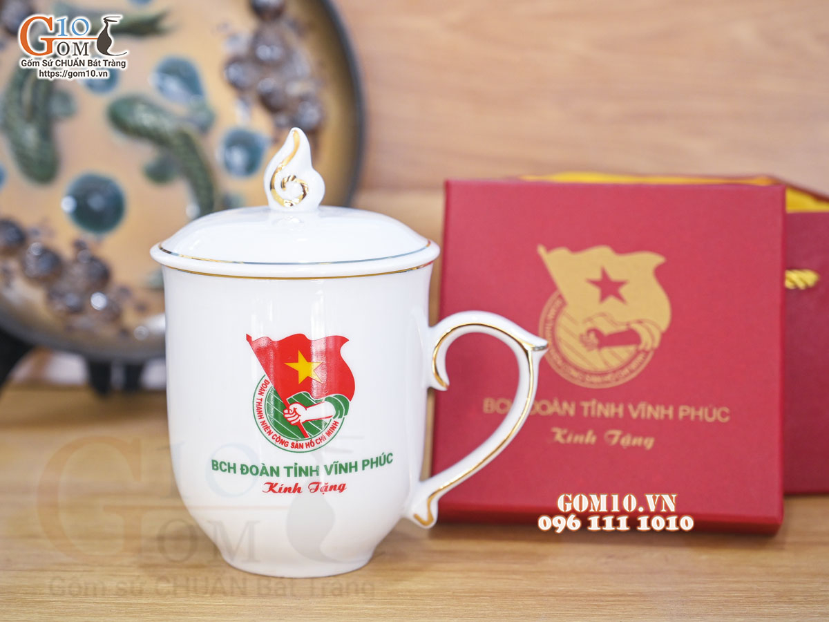 Cốc sứ dáng chóp lửa men trắng có nắp kẻ chỉ vàng kim, in logo quà tặng